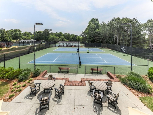 5039 Towne Lake Hls N, Woodstock, GA 30189 - view of tennis court with community basketball court and view of wooded area