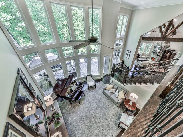 5039 Towne Lake Hls N, Woodstock, GA 30189 - living room with a high ceiling, ceiling fan, and ornamental molding