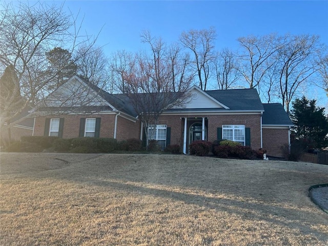 view of front of property with a front lawn and brick siding