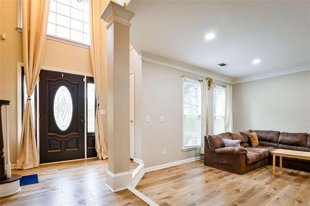 foyer entrance featuring baseboards, ornamental molding, decorative columns, recessed lighting, and wood finished floors