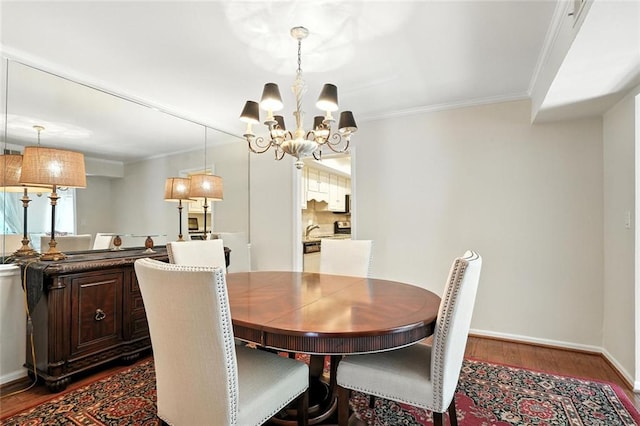 6851 Roswell Rd Unit F5, Sandy Springs, GA 30328 - dining area with wood finished floors, crown molding, and a chandelier