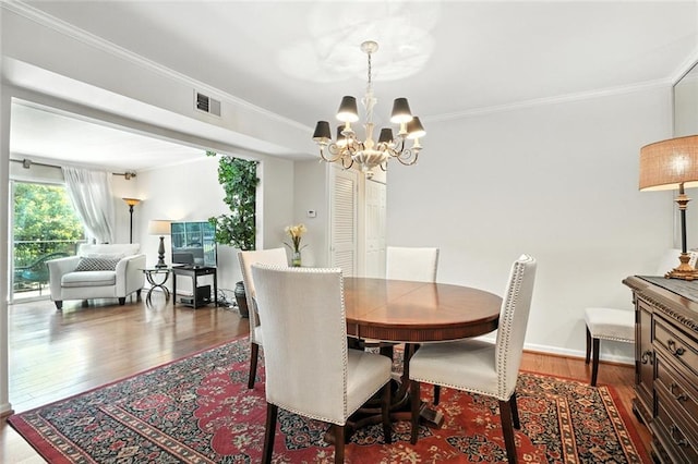 6851 Roswell Rd Unit F5, Sandy Springs, GA 30328 - dining area featuring wood finished floors, a chandelier, and crown molding