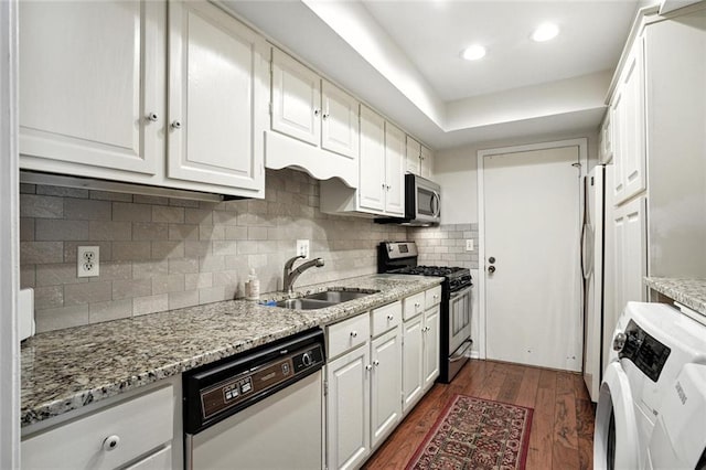 6851 Roswell Rd Unit F5, Sandy Springs, GA 30328 - kitchen with appliances with stainless steel finishes, white cabinets, dark wood-style flooring, backsplash, and light stone countertops