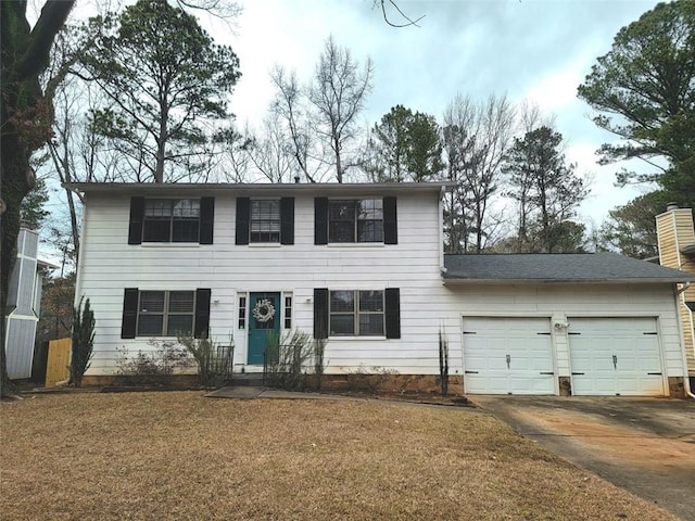 colonial home with a front lawn and a garage