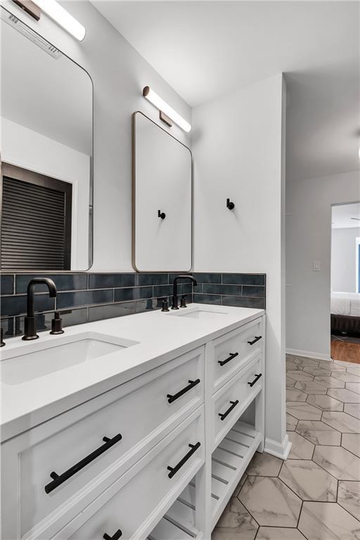 bathroom featuring vanity and backsplash