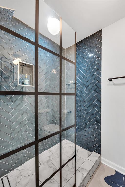 bathroom with a tile shower