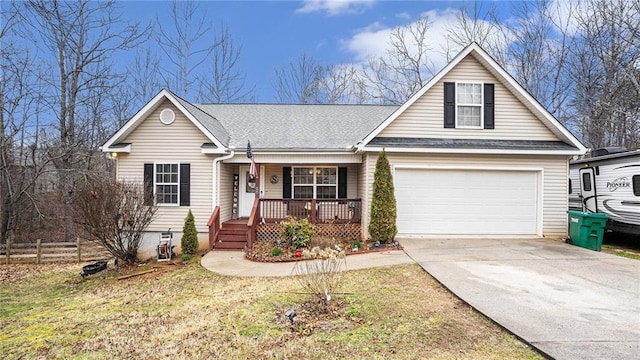 view of front facade with covered porch, driveway, a shingled roof, and an attached garage