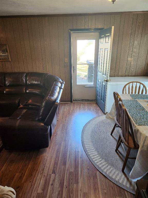 living room with wood walls and hardwood / wood-style floors