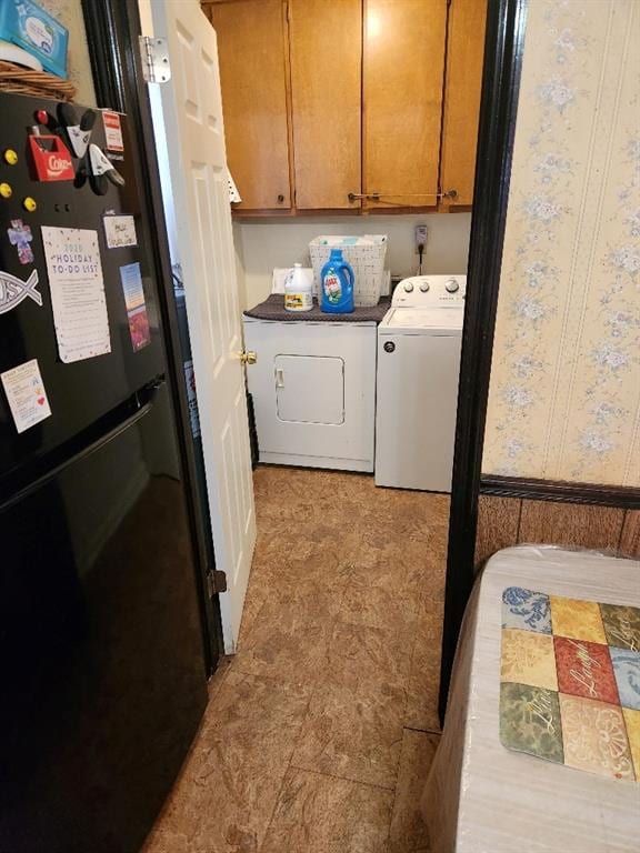 laundry area with cabinets and washer and clothes dryer