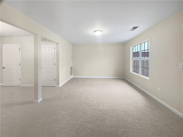 interior space featuring carpet floors, visible vents, and baseboards