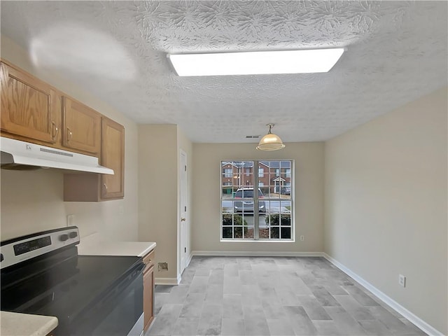 kitchen with visible vents, stainless steel range with electric cooktop, a textured ceiling, under cabinet range hood, and baseboards