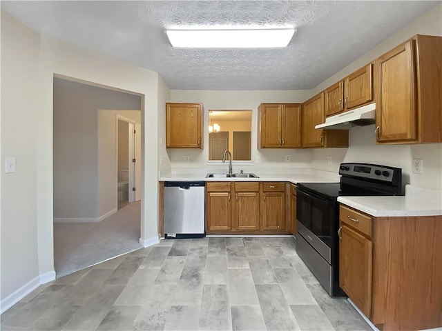 kitchen featuring electric range, brown cabinetry, a sink, dishwasher, and under cabinet range hood