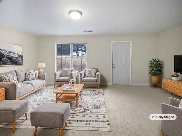 carpeted living room with visible vents and baseboards