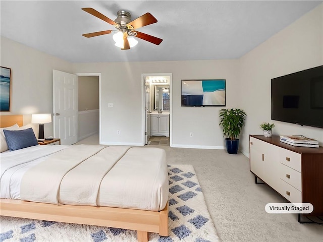 bedroom featuring light carpet, baseboards, connected bathroom, ceiling fan, and a sink