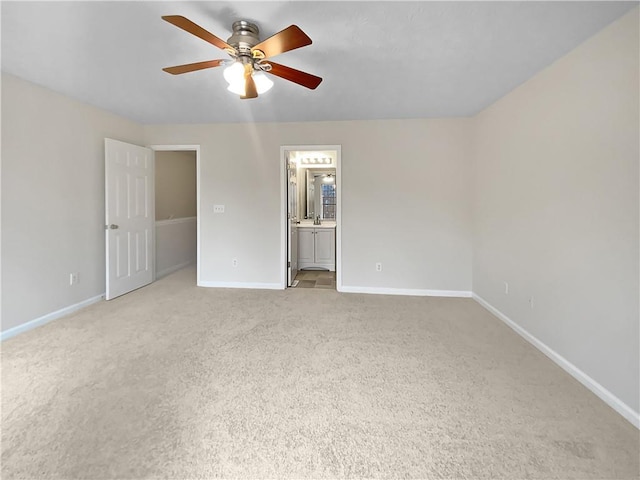 unfurnished room featuring a ceiling fan, light carpet, and baseboards