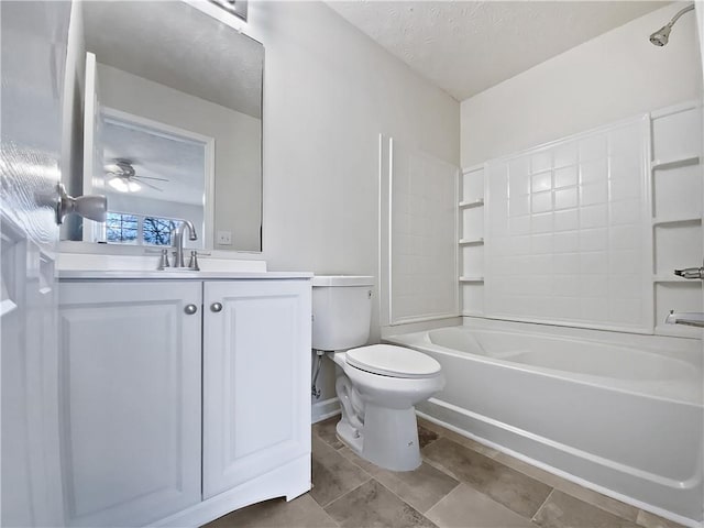 bathroom with a textured ceiling, ceiling fan, toilet, bathing tub / shower combination, and vanity