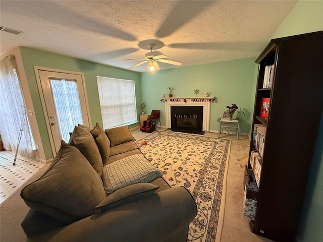 living room featuring a textured ceiling and ceiling fan