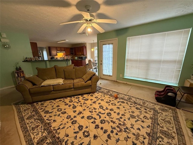 living room featuring a textured ceiling and ceiling fan