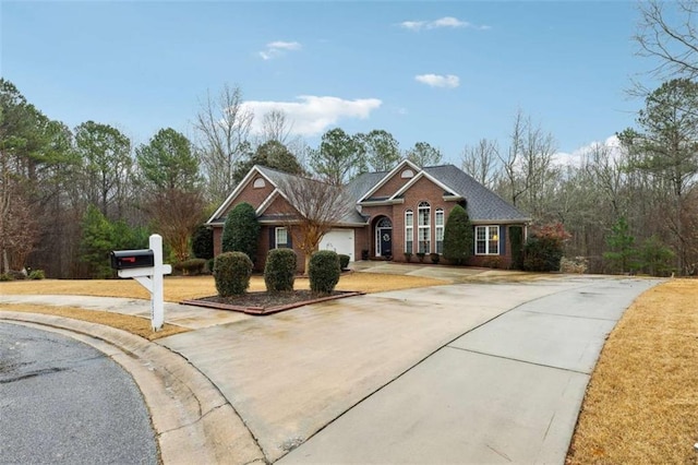 view of front of house with concrete driveway and brick siding