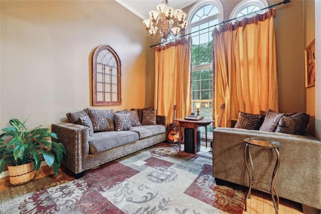 living room featuring ornamental molding, lofted ceiling, wood finished floors, and an inviting chandelier