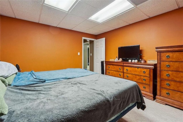 carpeted bedroom with a drop ceiling