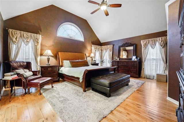 bedroom featuring light wood-type flooring, ceiling fan, and high vaulted ceiling