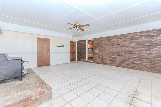 living room featuring brick wall and a ceiling fan