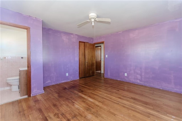 empty room with ceiling fan and wood finished floors