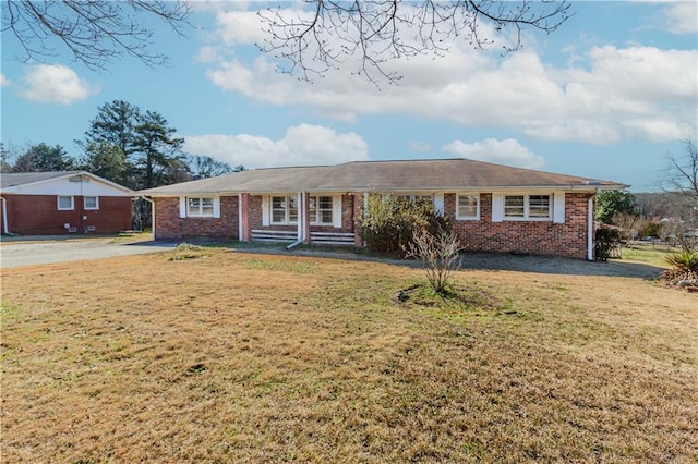 single story home featuring a front yard and brick siding