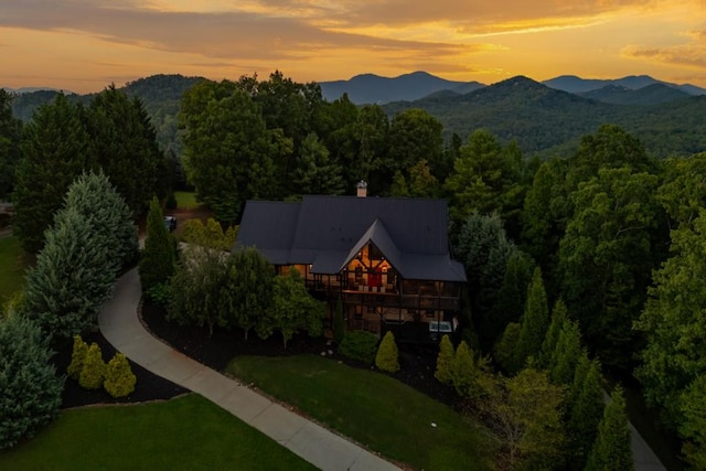 aerial view at dusk featuring a mountain view