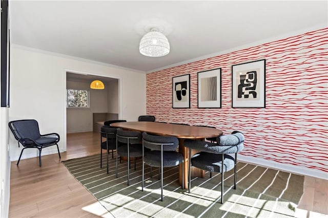 dining area featuring hardwood / wood-style floors and ornamental molding