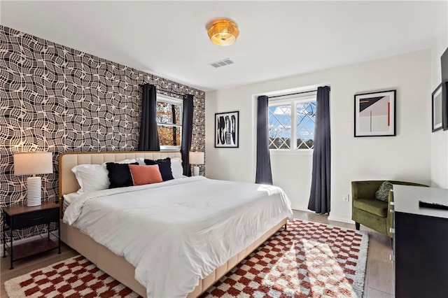 bedroom featuring multiple windows and light hardwood / wood-style floors