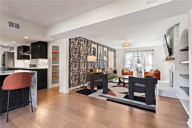 dining space featuring a fireplace and light wood-type flooring