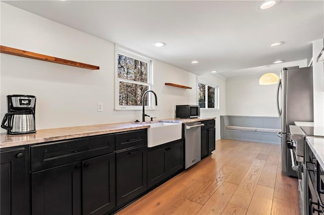 kitchen with sink, light hardwood / wood-style flooring, and stainless steel appliances