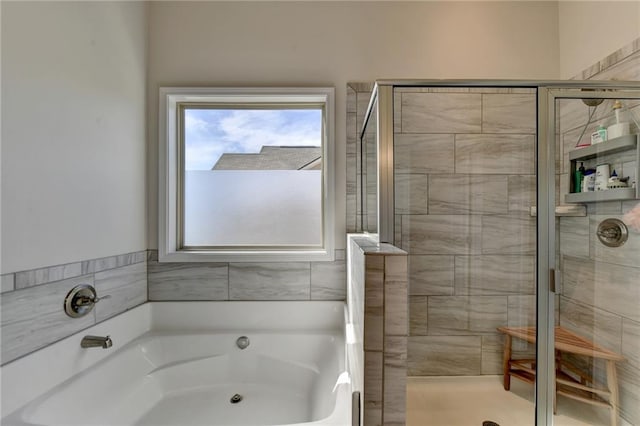 bathroom featuring separate shower and tub