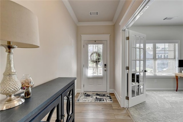 entryway featuring beverage cooler, ornamental molding, and wood-type flooring