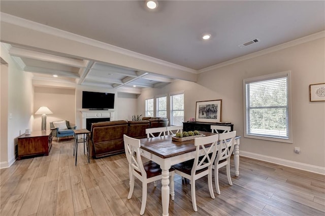 dining area featuring crown molding, coffered ceiling, beamed ceiling, and light wood-type flooring