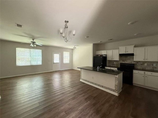 6446 Grey Fox Way, Riverdale, GA 30296 - kitchen with range with electric stovetop, dark countertops, freestanding refrigerator, decorative backsplash, and open floor plan