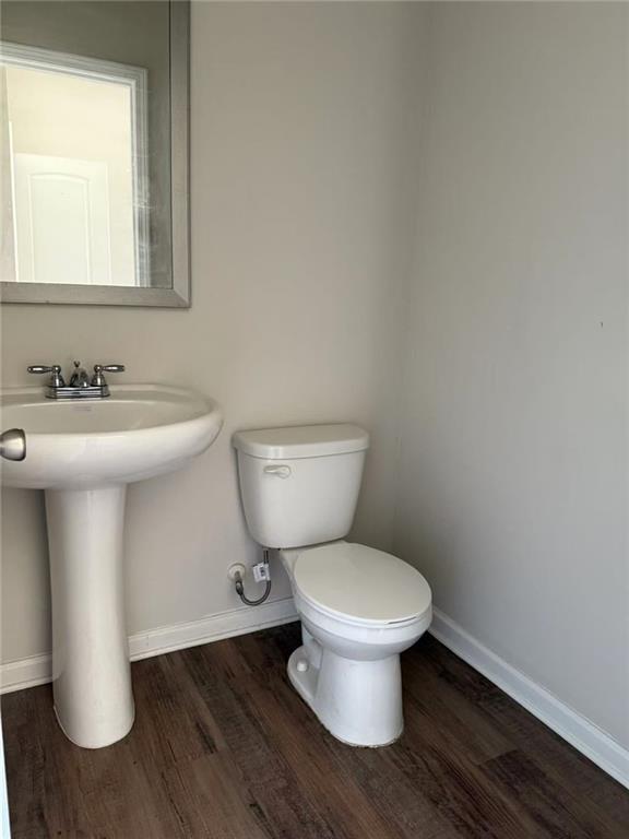 6446 Grey Fox Way, Riverdale, GA 30296 - bathroom featuring wood finished floors, baseboards, toilet, and a sink