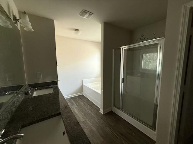 6446 Grey Fox Way, Riverdale, GA 30296 - bathroom with wood finished floors, a bath, a stall shower, double vanity, and baseboards