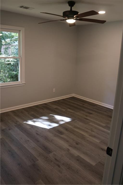 empty room with ceiling fan and dark hardwood / wood-style floors