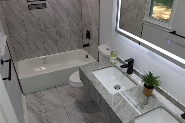 full bathroom with vanity, toilet, and tiled shower / bath