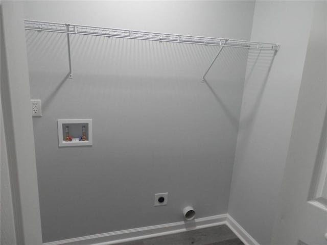 clothes washing area with laundry area, hookup for a washing machine, electric dryer hookup, and baseboards