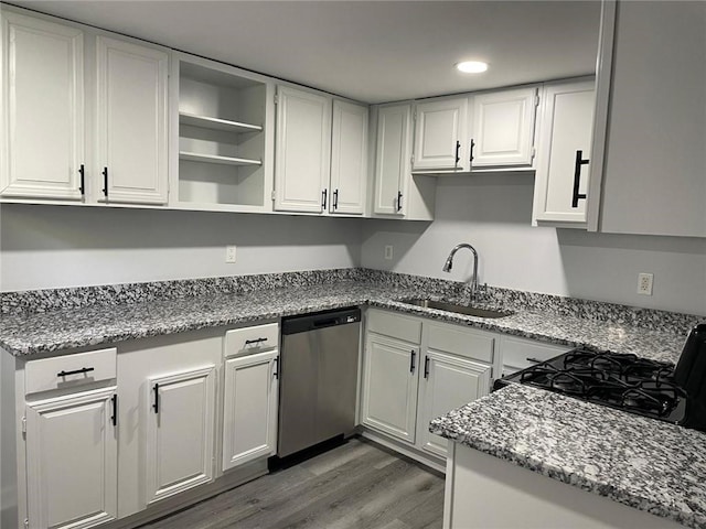 kitchen with dark hardwood / wood-style floors, dishwasher, stone countertops, sink, and white cabinets