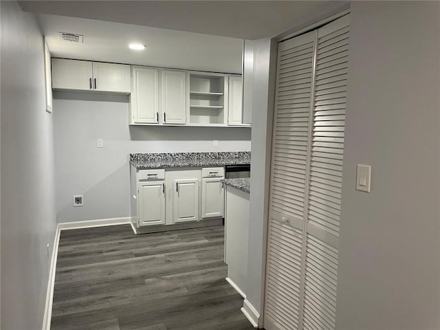 kitchen with visible vents, dark wood-type flooring, open shelves, white cabinetry, and baseboards