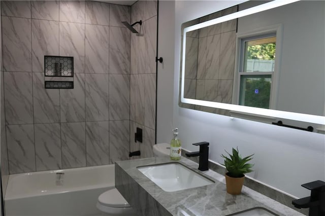 full bathroom with tiled shower / bath combo, vanity, and toilet