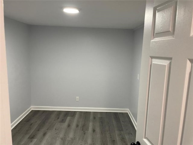 spare room featuring dark wood-type flooring