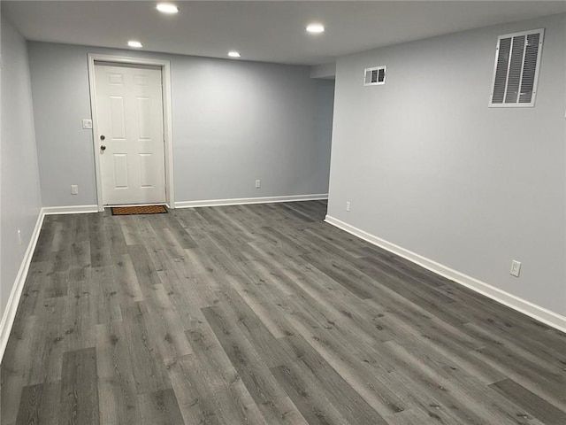 finished basement with recessed lighting, visible vents, baseboards, and dark wood-style floors