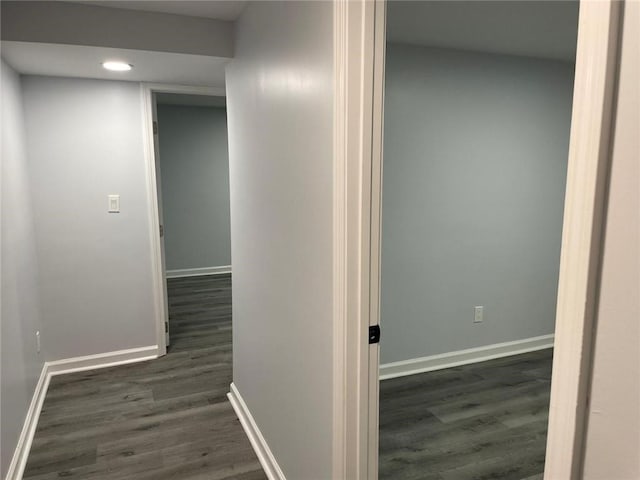 corridor featuring recessed lighting, baseboards, and dark wood finished floors