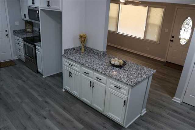 kitchen featuring stainless steel appliances, dark hardwood / wood-style floors, light stone countertops, and white cabinetry